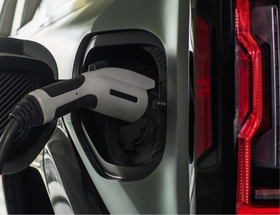Close up of charging port with charger plugged in on a GMC Hummer EV SUV - Russell Barnett GMC in WINCHESTER TN